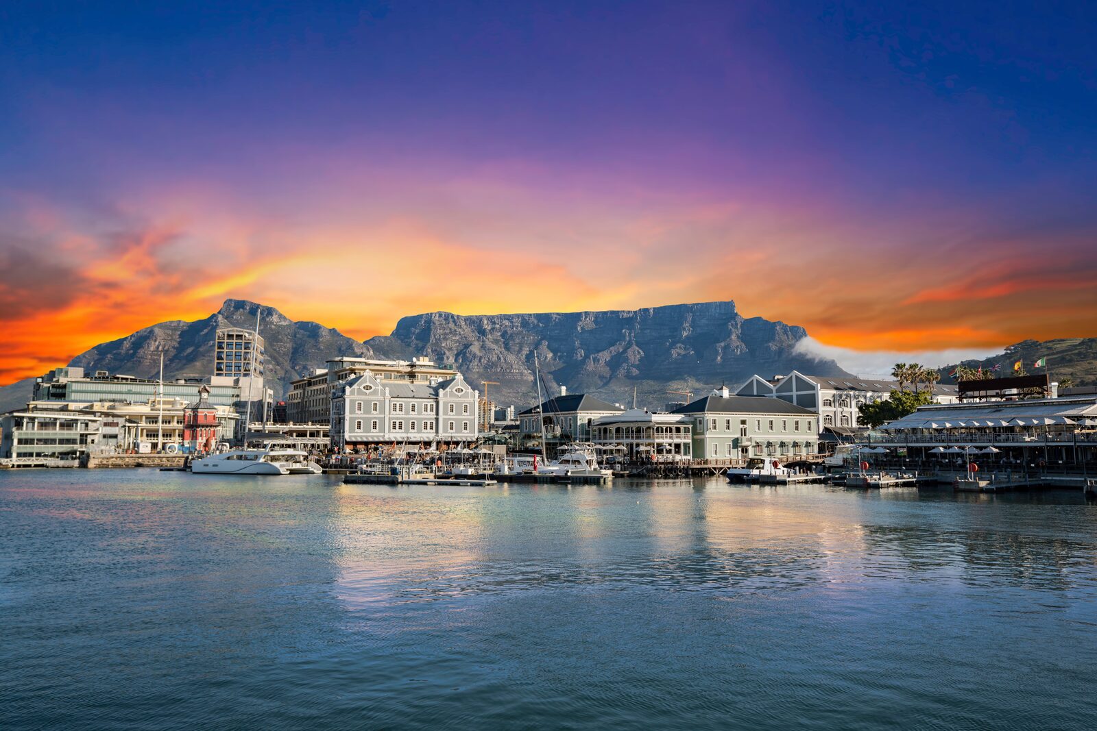 V&A Waterfront Cape Town with Table Mountain at sunset — complimentary hotel pickup